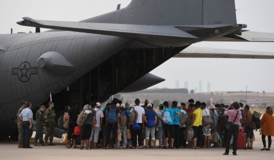 Refugees board a U.S. aircraft heading to Germany, after being evacuated from Kabul to Spain on Aug. 24, 2021.