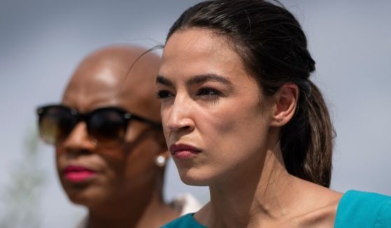 Democratic Reps. Alexandria Ocasio-Cortez of New York, right, and Ayanna Pressley of Massachusetts look on during a news conference on Capitol Hill in Washington on Tuesday.