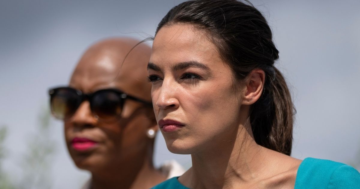 Democratic Reps. Alexandria Ocasio-Cortez of New York, right, and Ayanna Pressley of Massachusetts look on during a news conference on Capitol Hill in Washington on Tuesday.