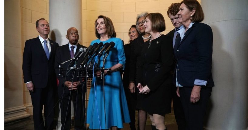 Arizona Democratic Rep. Ann Kirkpatrick, far right, is seen listening to California Rep. Nancy Pelosi along with other Democratic leaders, from left, Rep. Adam Schiff (D-CA), Rep. John Lewis (D-GA), Rep.-elect Veronica Escobar (D-TX), Rep. Joyce Beatty (D-OH), Rep. Kathy Castor (D-FL), and Rep. Joe Kennedy (D-MA) in this file photo from Nov. 28, 2018.