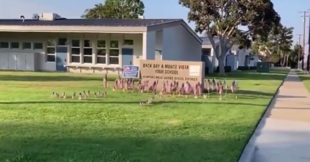 American flags are seen on the lawn in front of Back Bay High School in Orange County, California.