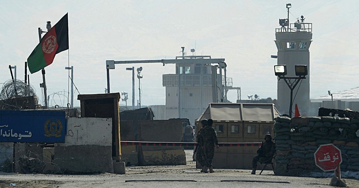 Afghan National Army soldiers stand guard at the Bagram prison gate on Feb. 13, 2014, in Afghanistan.