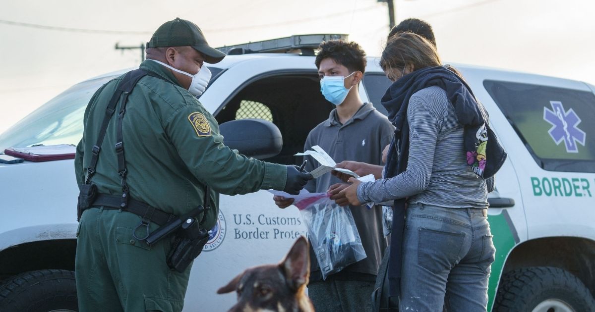 Migrants are processed by a Border Patrol agent after crossing the U.S.-Mexico border in Penitas, Texas, on July 8, 2021.