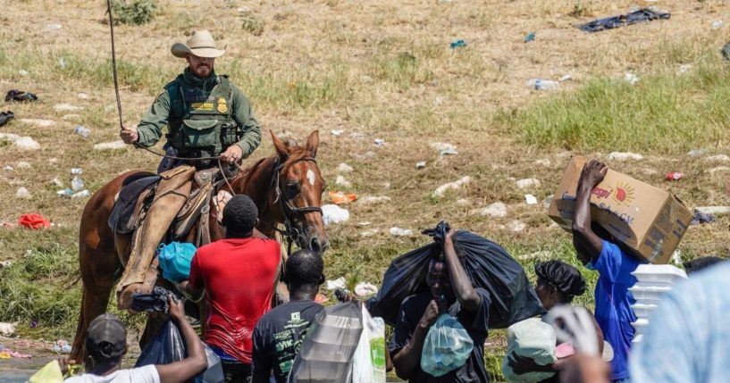 A Border Patrol agent on horseback uses the reins as he tries to stop Haitian migrants from entering an encampment on the banks of the Rio Grande near the Acuna Del Rio International Bridge in Del Rio, Texas, on Sunday.
