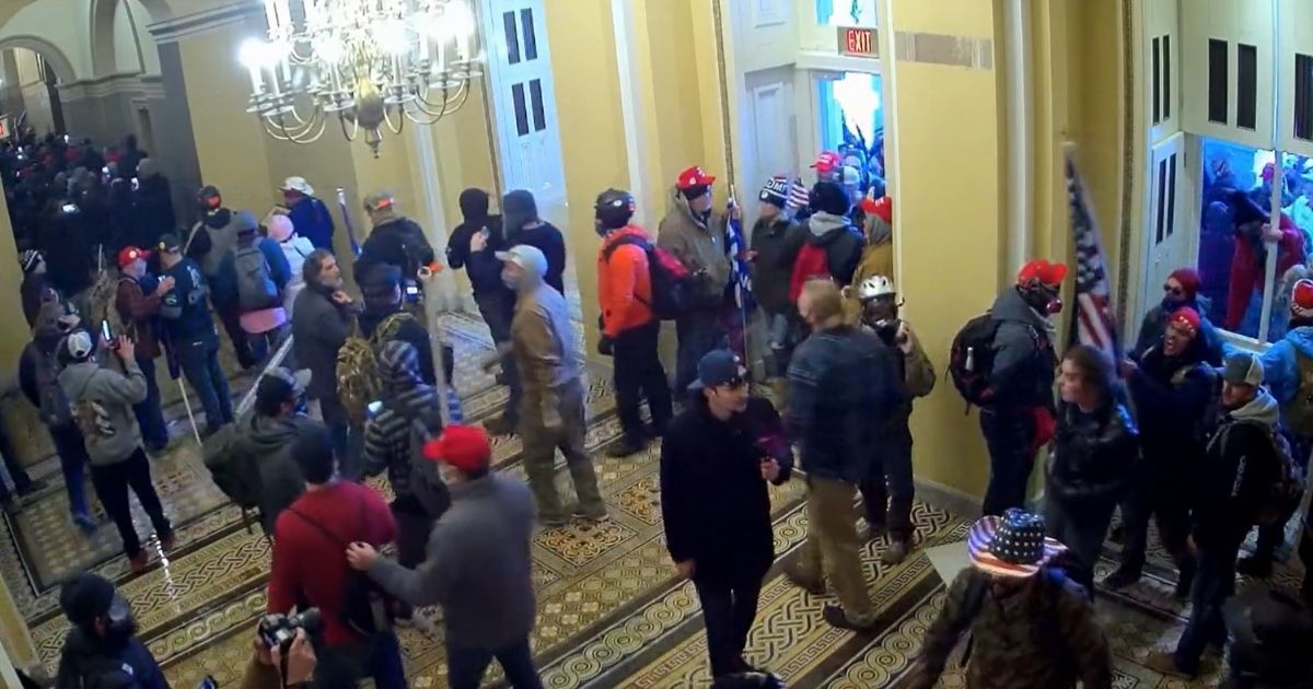 People mill out the Capitol after entering the building on Jan. 6.