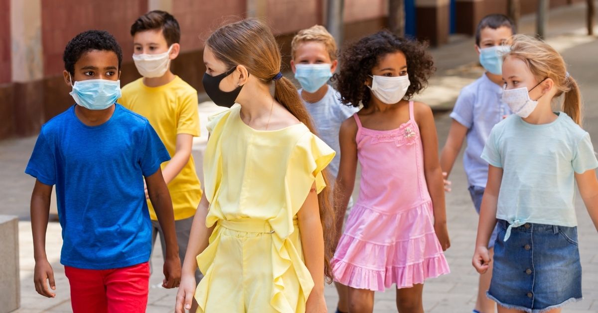 Children are pictured wearing masks in the stock image above.