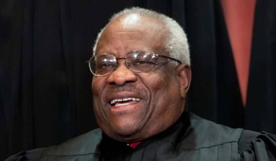 Supreme Court Associate Justice Clarence Thomas sits with fellow Supreme Court justices for a group portrait at the Supreme Court Building in Washington, D.C., in 2018.