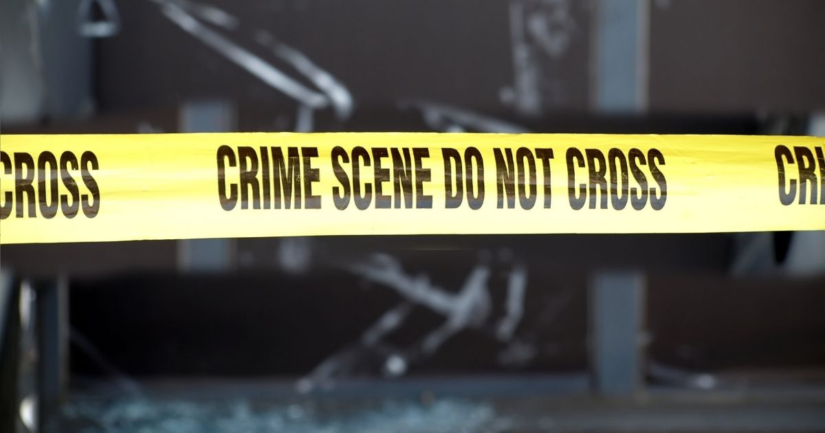 A crime scene with police tape is pictured in the stock image above.