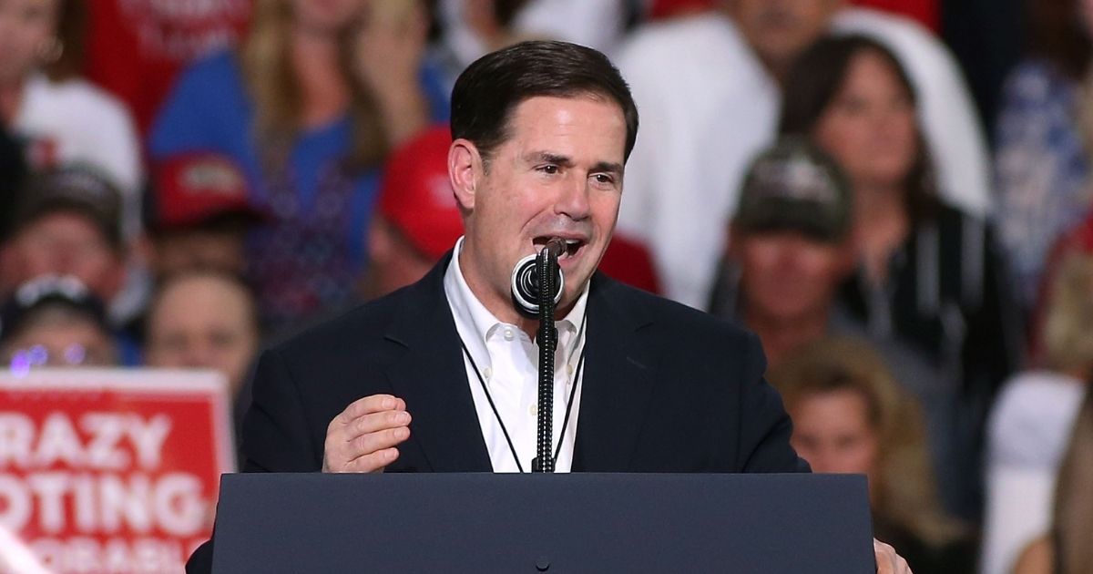 Arizona Gov. Doug Ducey speaks during a rally for then-President Donald Trump at the International Air Response facility on Oct. 19, 2018, in Mesa, Arizona.
