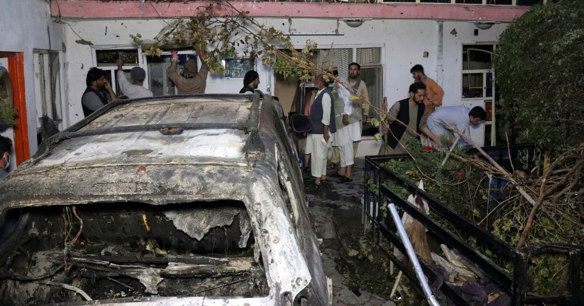 Afghans inspect the damage on a family house after a U.S. drone strike in Kabul, Afghanistan, on Aug. 29, 2021.