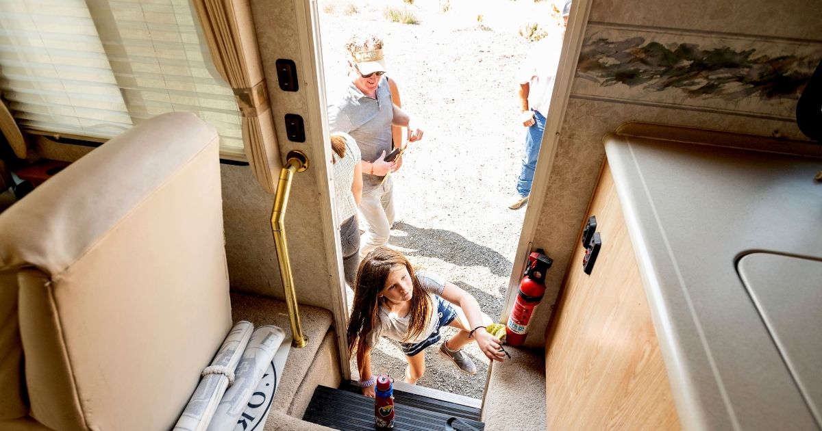 Luna Faircloth boards a donated RV while delivering it to a Dixie Fire victim on Sept. 5, 2021, in Sierra County, Calif. Behind her is dad Woody Faircloth, who runs the non-profit EmergencyRV.org.