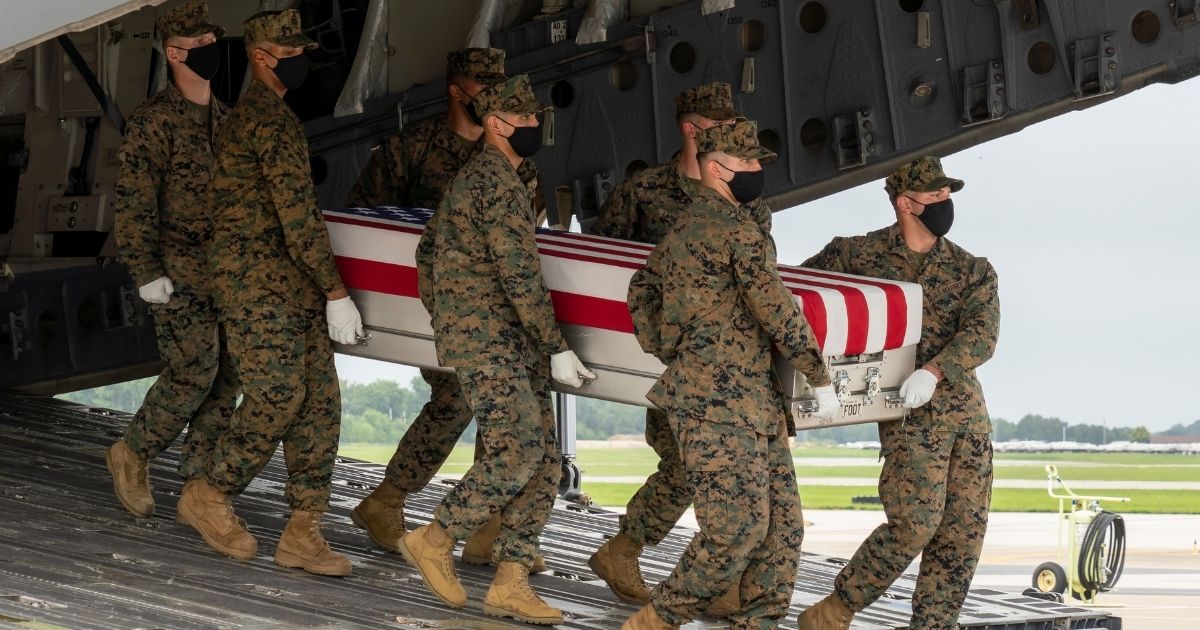 A U.S. Marine Corps carry team transfers the remains of Marine Corps Cpl. Humberto A. Sanchez on Aug. 29, 2021, at Dover Air Force Base, Delaware.