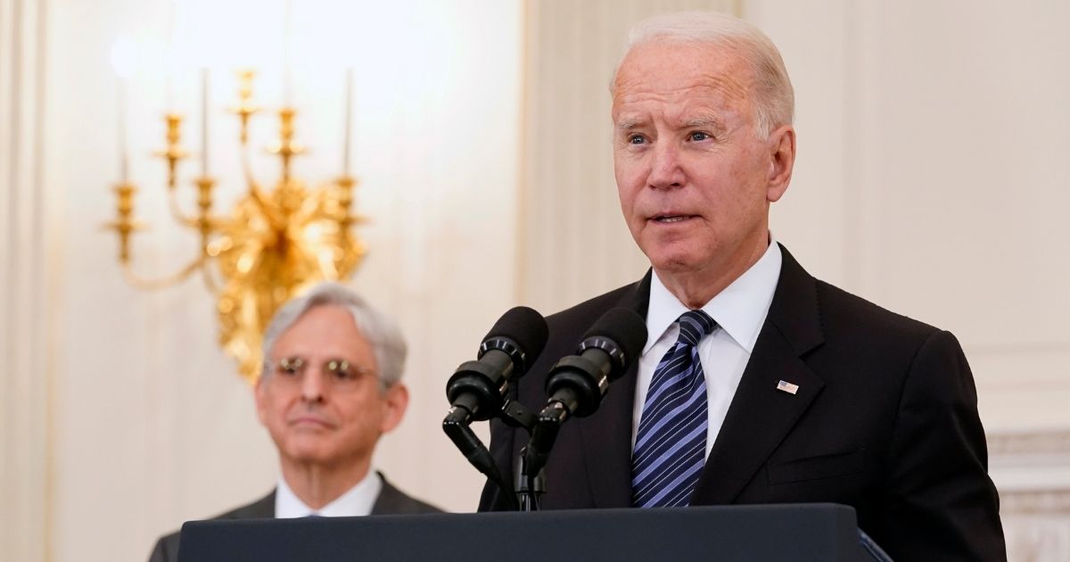 Attorney General Merrick Garland listens as President Joe Biden speaks in the State Dining room of the White House in Washington on June 23.