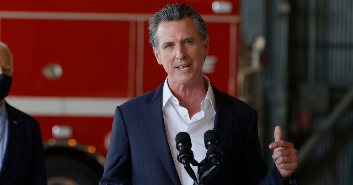 California Gov. Gavin Newsom speaks after a helicopter tour of the Caldor Fire, at Mather Airport on Sept. 13, 2021, in Mather, California.