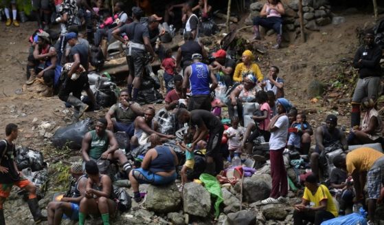 Haitian migrants heading to Panama rest while crossing the jungle near Acandi, Colombia, on Sunday.