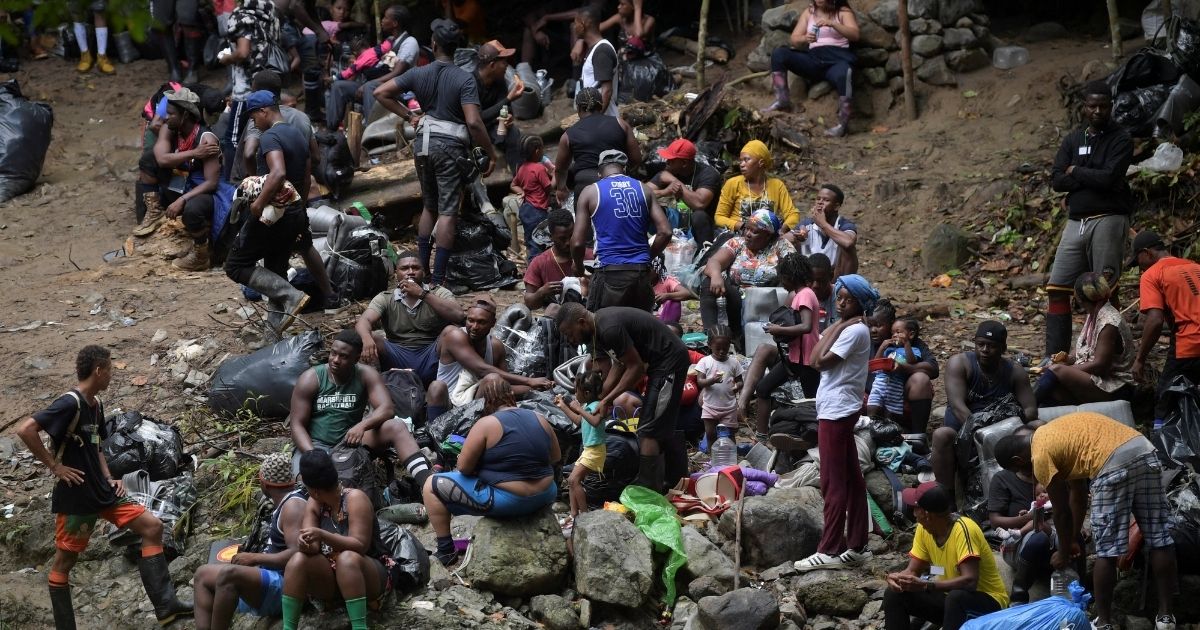 Haitian migrants heading to Panama rest while crossing the jungle near Acandi, Colombia, on Sunday.