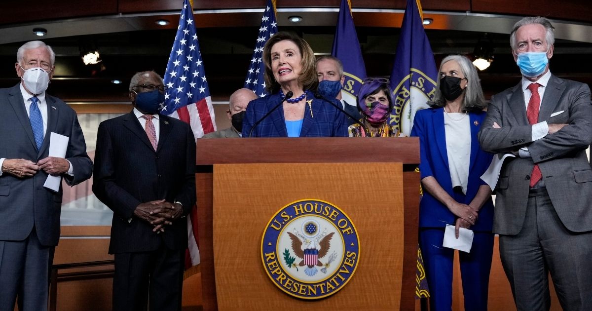 Speaker of the House Nancy Pelosi, surrounded by fellow congressional Democrats, speaks during a news conference on Capitol Hill in Washington on July 30.
