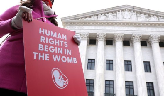 A pro-life activist holds a sign outside the U.S. Supreme Court during the 48th annual March for Life on Jan. 29, 2021 in Washington, D.C.