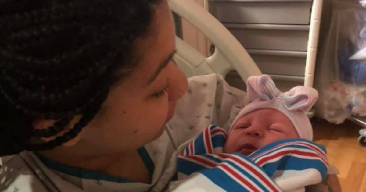 Jiennah Crayton, widow of Lance Cpl. Rylee McCollum, holds her newborn daughter, Levi Rylee Rose McCollum, after her birth on Monday.
