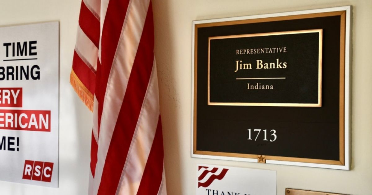 Republican Indiana Rep. Jim Banks displays a poster outside his congressional office on Friday.
