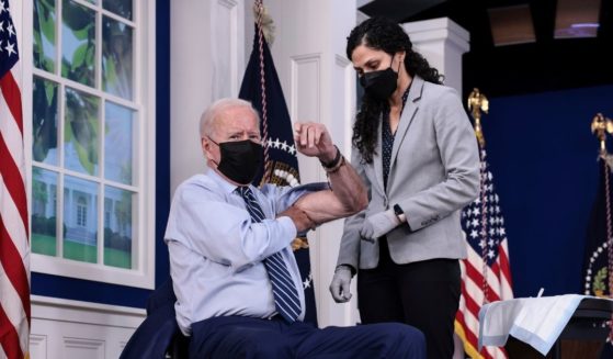 President Joe Biden rolls up his sleeve before receiving a third dose of the Pfizer-BioNTech COVID-19 vaccine at the White House on Monday.