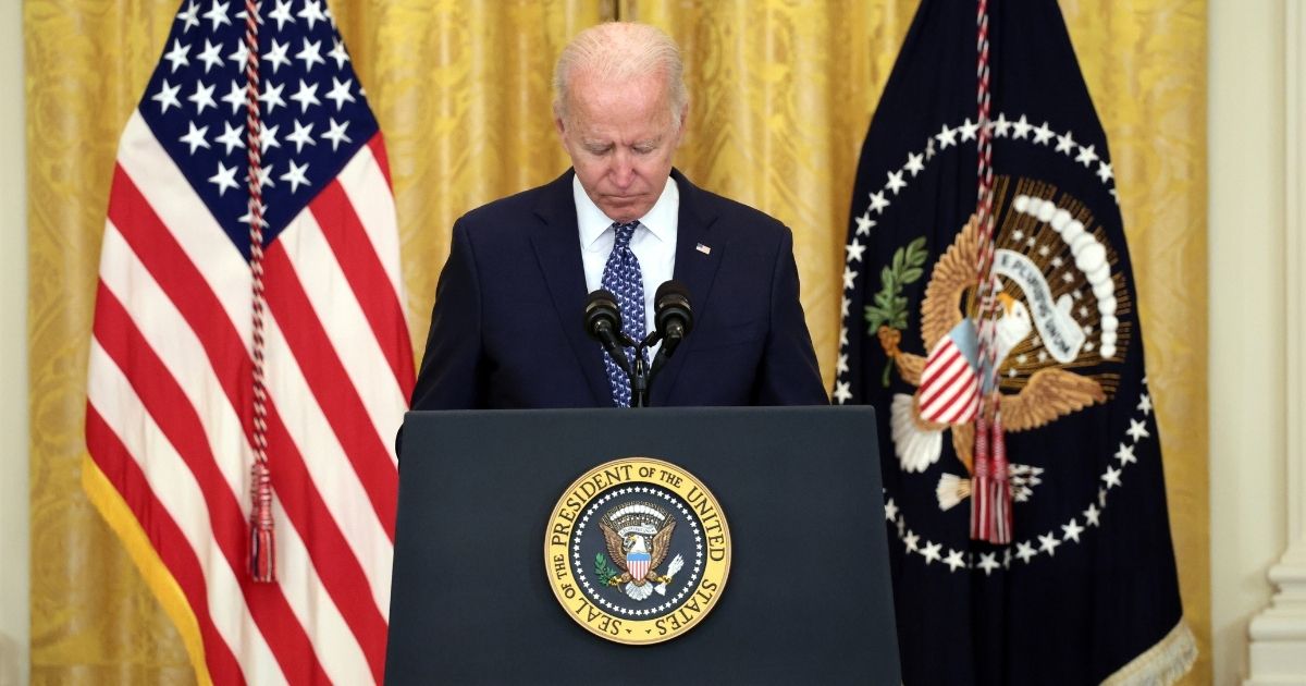 President Joe Biden holds a moment of silence for workers who have died of COVID-19 in the East Room of the White House on Wednesday in Washington, D.C.