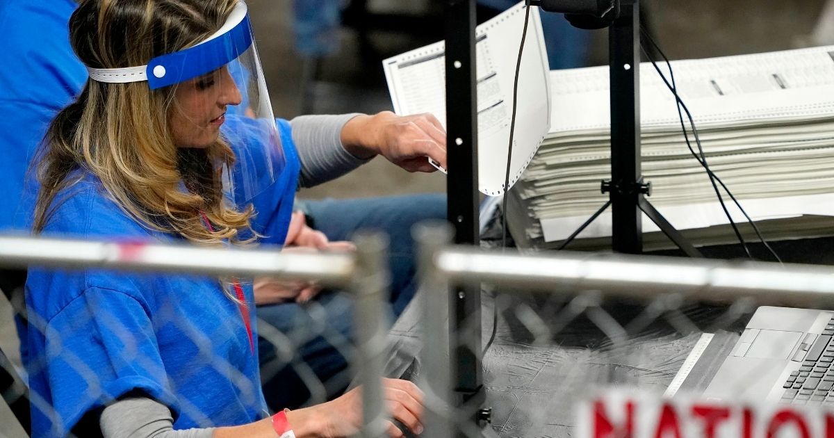 Ballots cast in the 2020 general election in Maricopa County, Arizona, are examined and recounted by contractors working for the Florida-based company Cyber Ninjas at Veterans Memorial Coliseum in Phoenix on May 6.