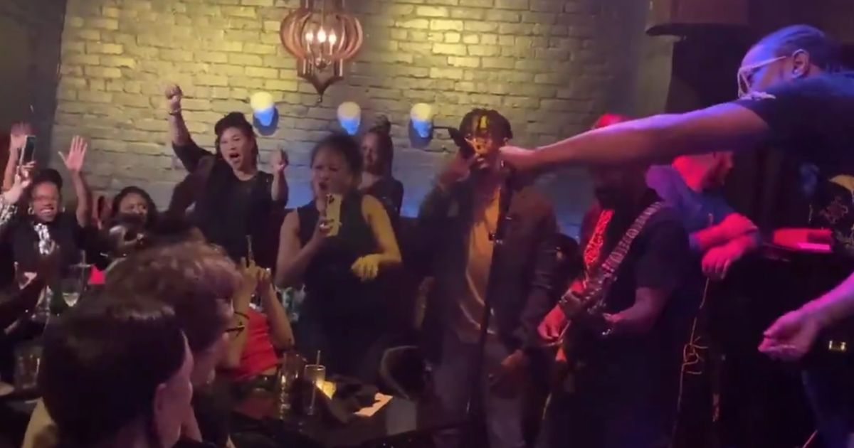 San Francisco Mayor London Breed, standing, left, has been criticized for partying maskless at a nightclub despite her city's strict mask mandates.