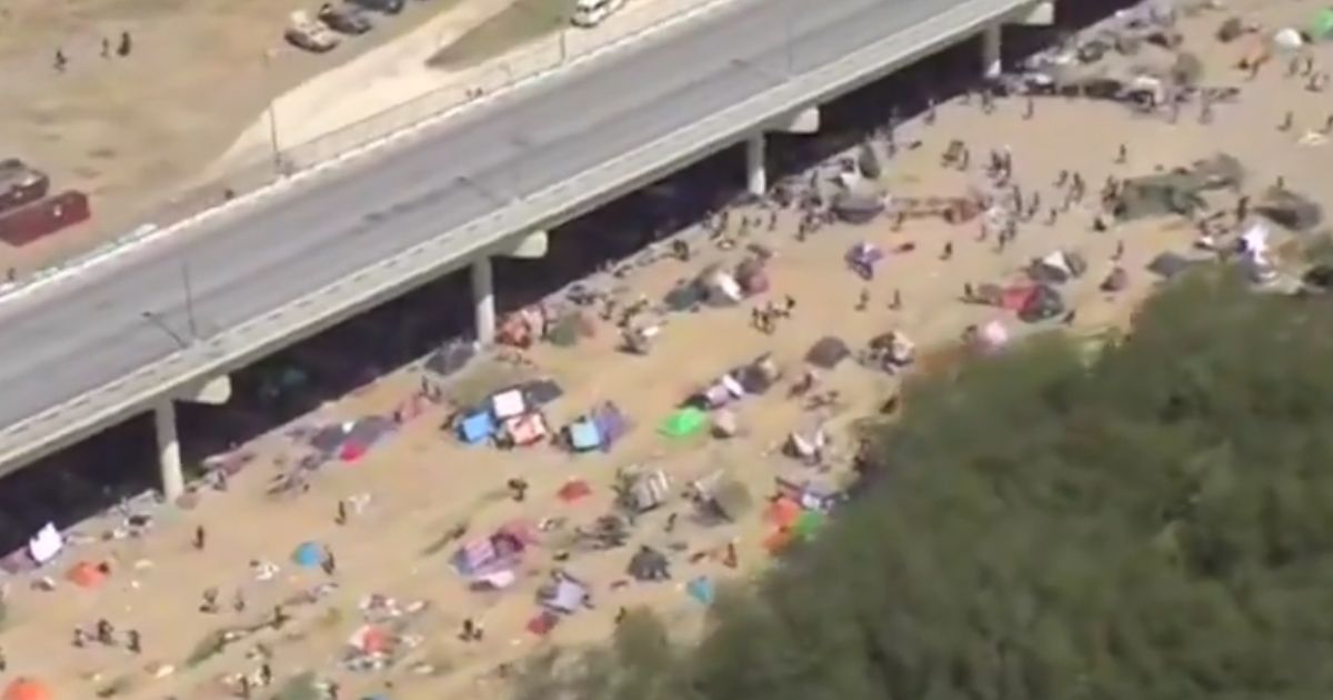 A Fox news crew captured video of thousands of migrants camped around a bridge in Texas Friday, Sept. 17, 2021, after crossing illegally into the U.S.