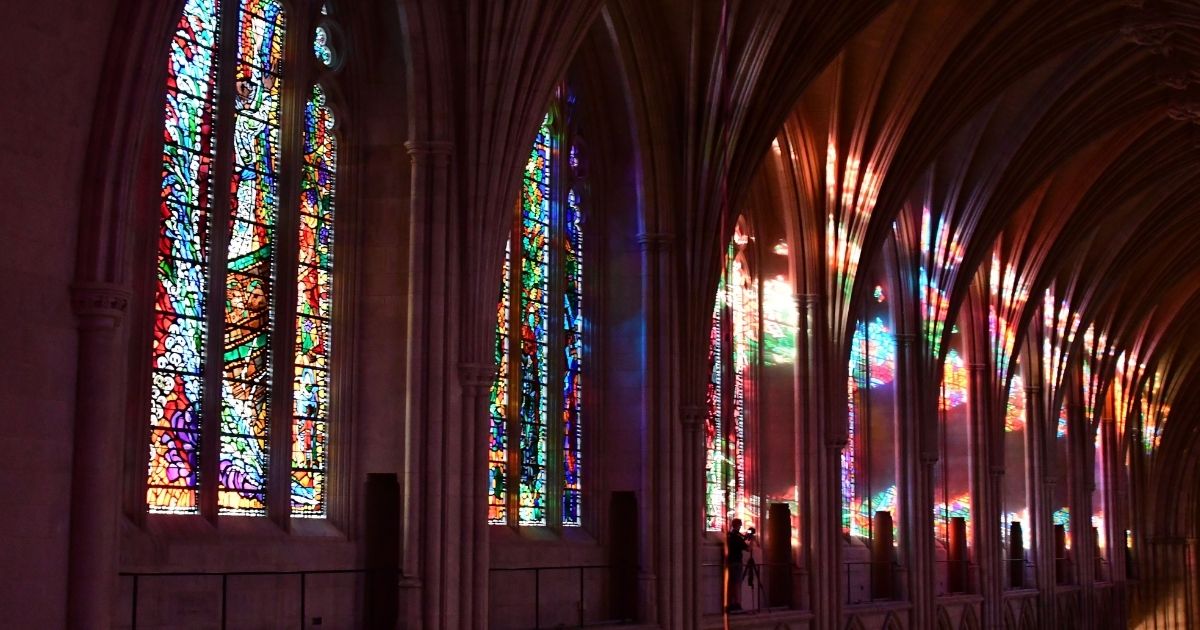 Sunlight filters through the stained glass windows inside the National Cathedral in Washington, DC in this file photo from June 20, 2017.