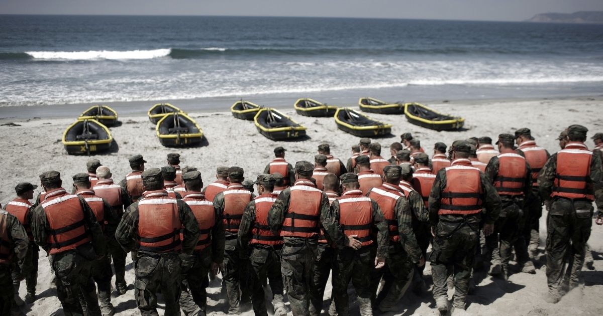 Navy SEAL trainees participate in a Hell Week exercise on a beach in Coronado, California, in August 2010.