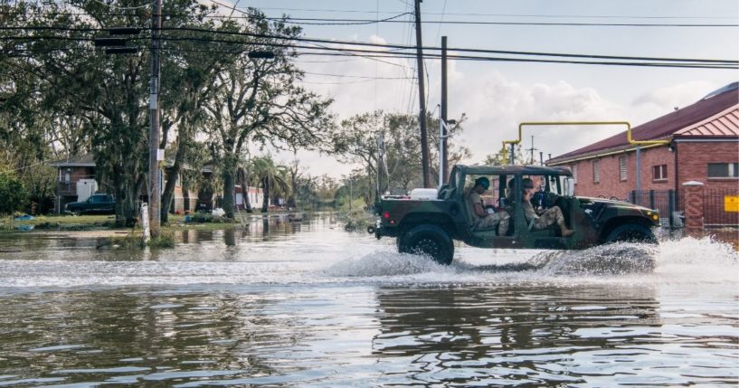 Members of the National Guard drive through floodwater on Wednesday in Jean Lafitte, Louisiana.