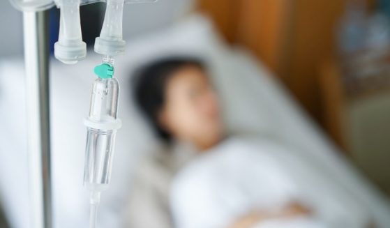 A hospital patient with an IV bag is pictured in the stock image.