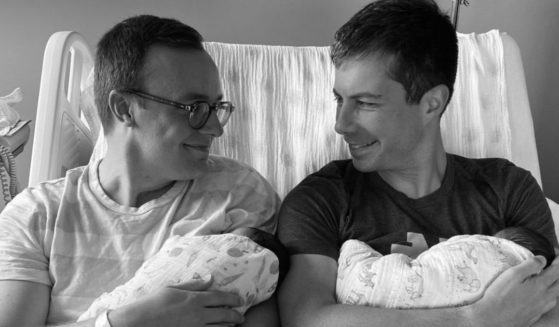 Transportation Secretary Pete Buttigieg, left, and his husband Chasten have adopted two newborns.