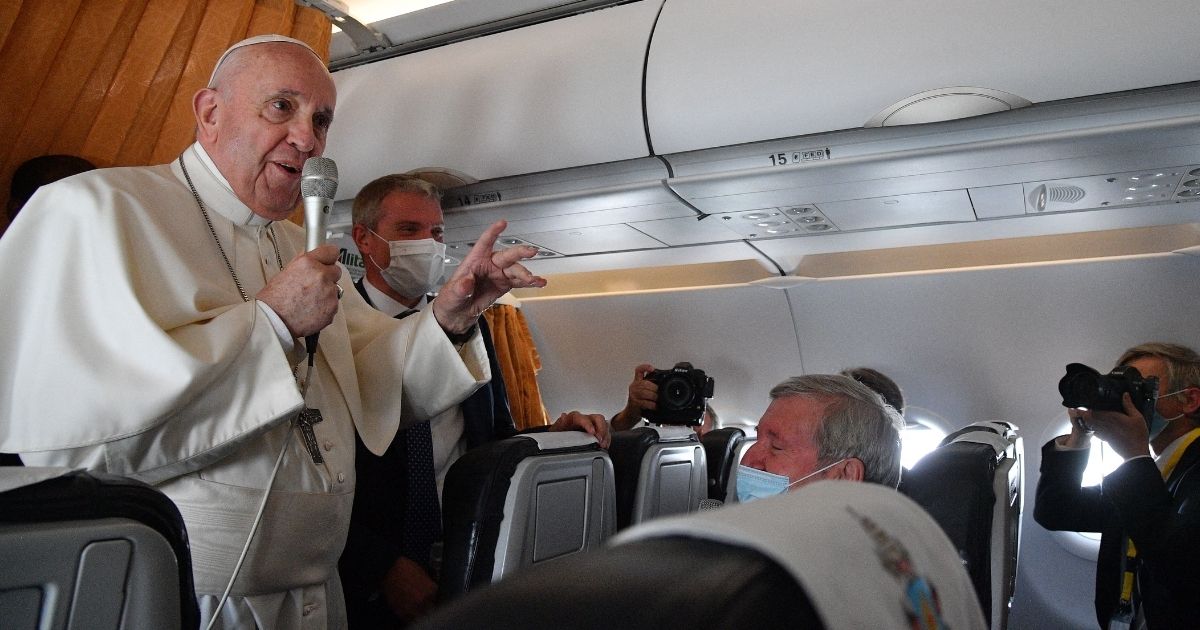Pope Francis speaks with journalists aboard an Alitalia aircraft en route from Milan Rastislav Stefanik International airport in Bratislava, Slovakia, back to Rome on Wednesday.