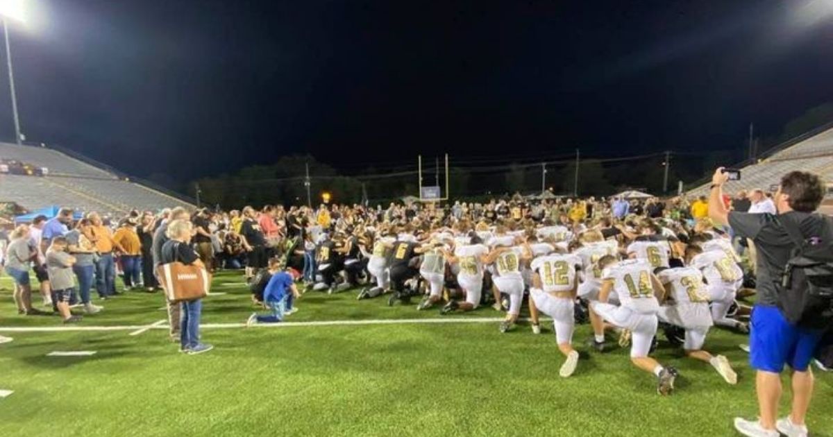 Upperman and Stone Memorial high school football players lead fans in prayer on the field after their game Friday night in Tennessee.