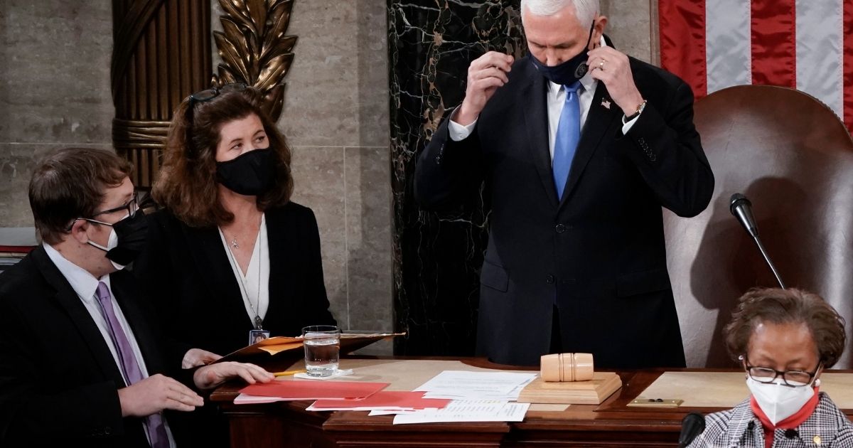 Senate Parliamentarian Elizabeth MacDonough, second from left, works beside then-Vice President Mike Pence during the certification of Electoral College ballots in the presidential election in the House chamber at the Capitol in Washington on Jan. 6.