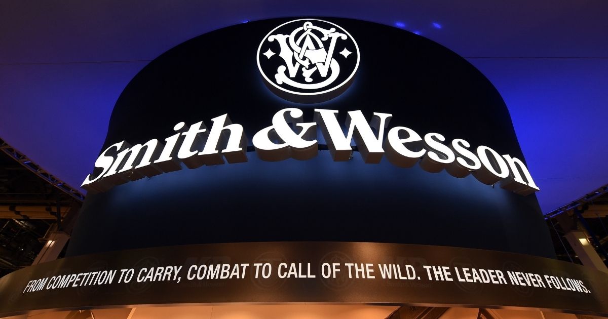 A sign at the Smith & Wesson booth is shown in this file photo from a 2016 trade show. Firearms manufacturer Smith & Wesson announced Thursday that it is moving its headquarters due to a "changing business climate for firearms manufacturing in Massachusetts." The company will relocate to Tennessee.