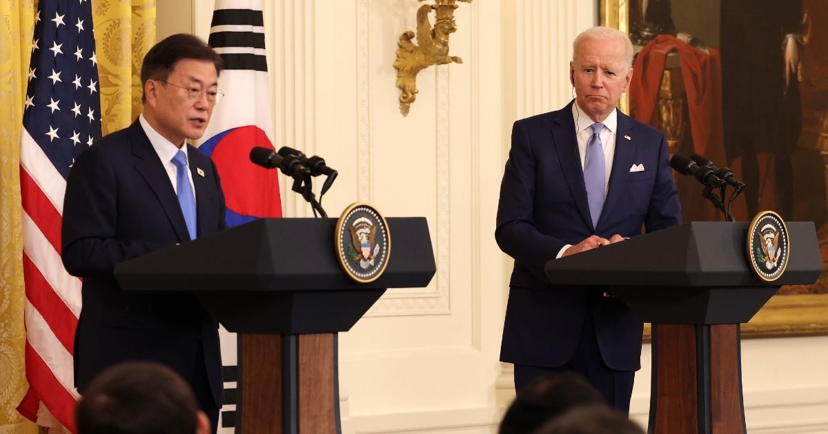 President Joe Biden, right, listens as South Korean President Moon Jae-in speaks at a joint news conference in the East Room of the White House on May 21, 2021, in Washington, D.C.
