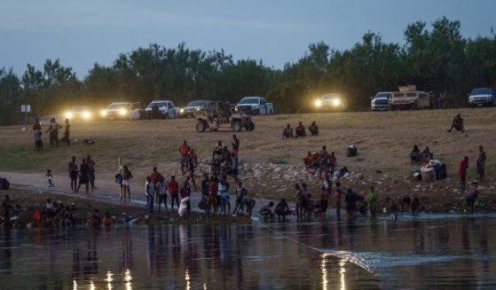 Vehicles from the U.S. Border Patrol, the National Guard and the Texas Department of Public Safety in Del Rio, Texas, shine their lights on the Rio Grande across from Ciudad Acuna, Mexico, on Tuesday.
