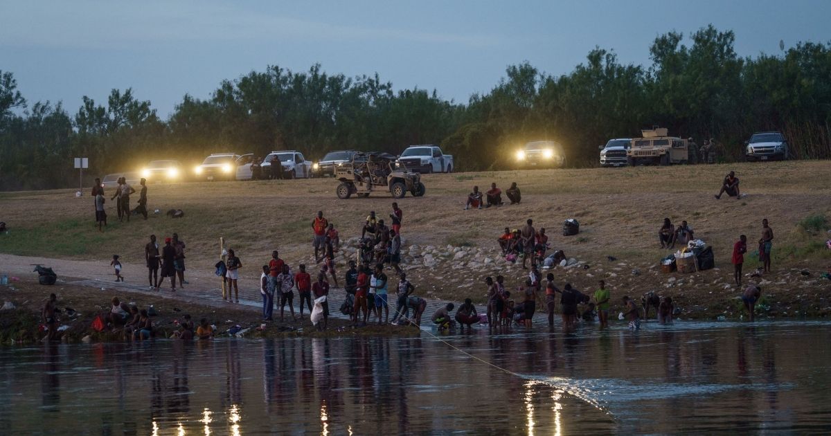 Vehicles from the U.S. Border Patrol, the National Guard and the Texas Department of Public Safety in Del Rio, Texas, shine their lights on the Rio Grande across from Ciudad Acuna, Mexico, on Tuesday.