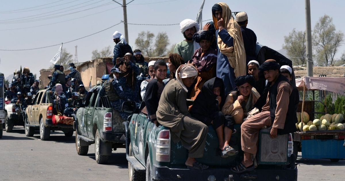 Taliban fighters atop vehicles parade along a road to celebrate after the U.S. pulled all its troops out of Afghanistan in Kandahar on Wednesday.