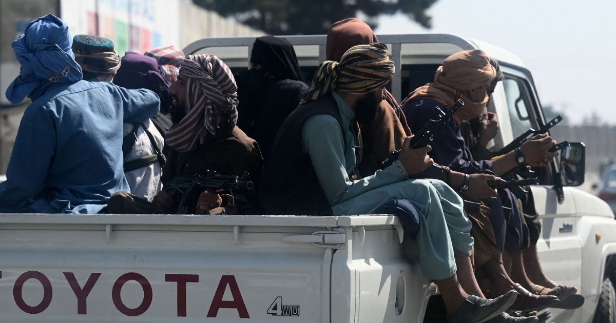 Taliban fighters patrol outside the Kabul airport on Saturday in Afghanistan.