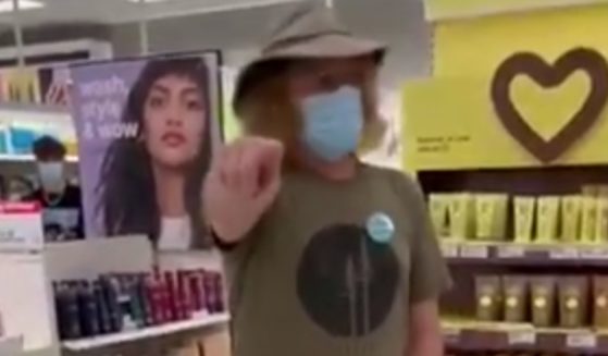 The masked man followed the unmasked woman around a Target store, pointing and telling her that she was a bad person and a bad American.