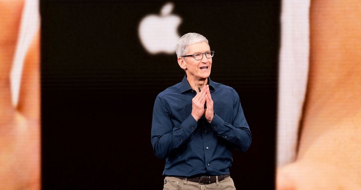 Apple CEO Tim Cook speaks in front of an iPhone graphic during a product launch event in Cupertino, California, on Sept. 12, 2018.