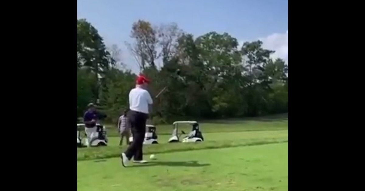 Former President Donald Trump hits a nice drive while playing golf.