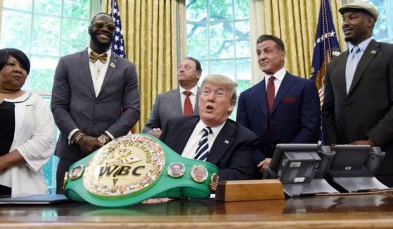 Then-President Donald Trump speaks after granting a posthumous pardon to former heavyweight champion Jack Johnson in the Oval Office of the White House on May 24, 2018. Attending the event were, from left, Linda Haywood, Johnson's great-great-niece; former heavyweight champ Deontay Wilder; businessman Keith Frankel; actor Sylvester Stallone; and former heavyweight champ Lennox Lewis.
