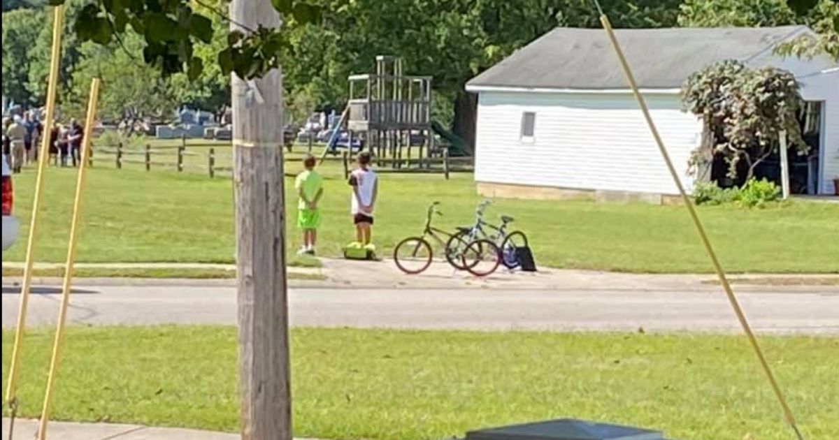 Two boys in Batesville, Indiana, stopped riding their bikes and stood at attention while TAPS played during a serviceman's funeral.