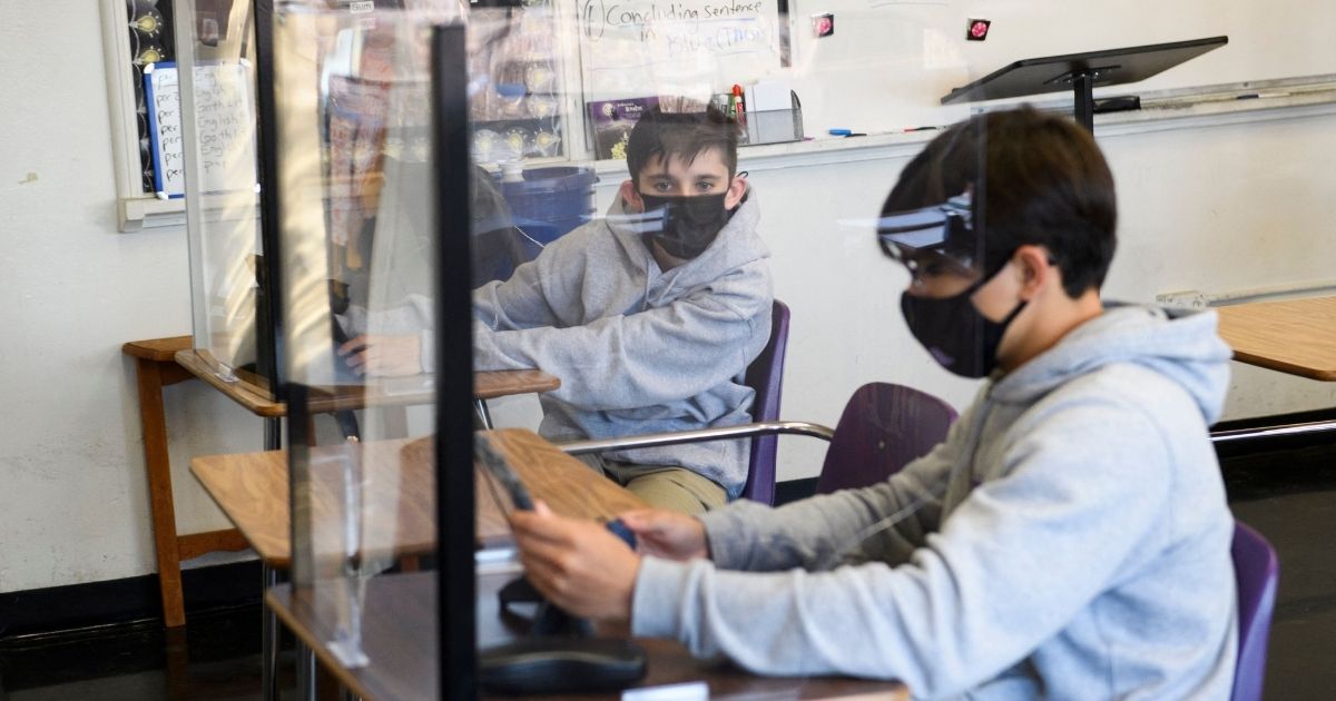 Students wear masks while sitting in class at St. Anthony Catholic High School in Long Beach, California, on March 24, 2021.
