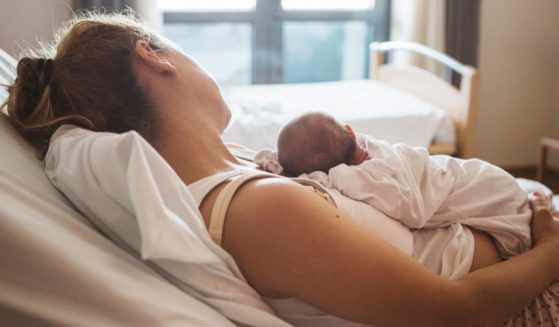 In this stock photo, a mother rests with her newborn baby in the hospital. In rural New York state, a hospital CEO says his facility has 'no choice but to pause' delivering babies because of a shortage of nurses.